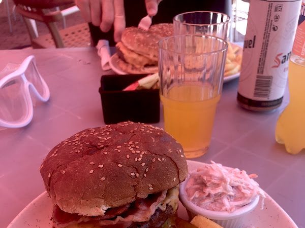 Char-grilled burger with a cold drink