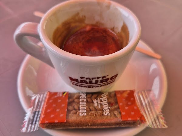 A €1 espresso with a biscuit on the seafront